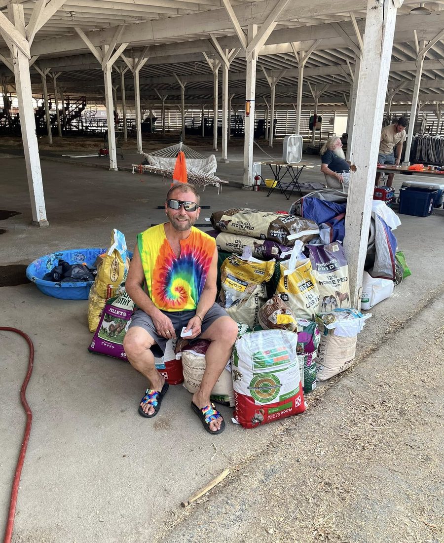 An SOEA volunteer with donated feed and pet supplies staged at the fairgrounds shelter